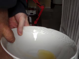 John is Pissing in a Bowl in Closeup