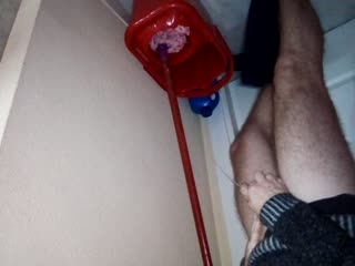 John is taking a Piss into the Cleaning Bucket