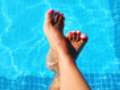 Bare feet in the pool .