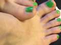 Petite feet and hands with neon nail polish