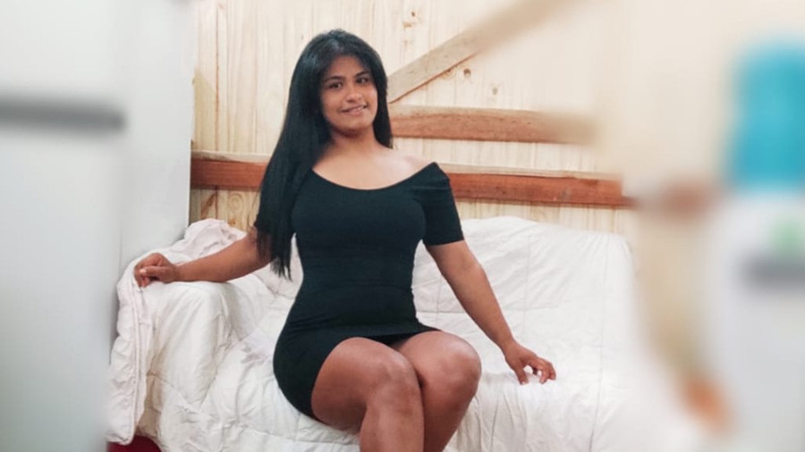 In a black mini dress, from all sides