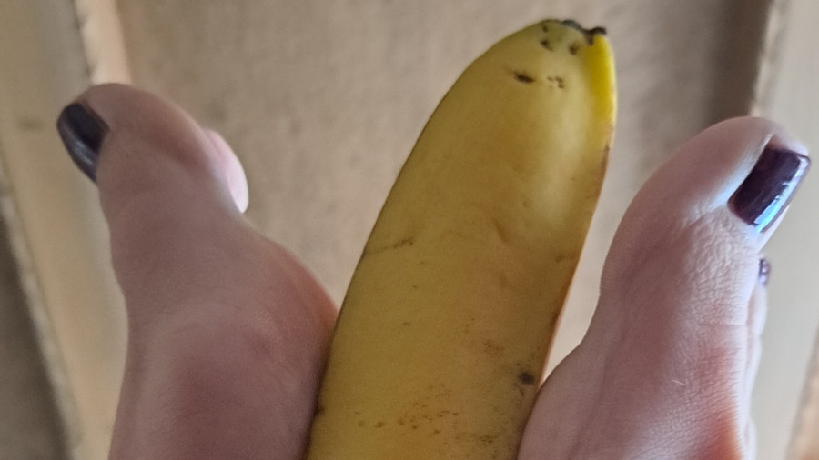 Meine Füße spielen mit einer Banane