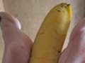 Meine Füße spielen mit einer Banane