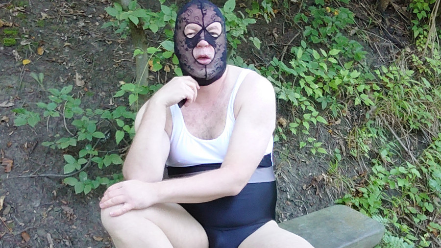 Masked fetish striptease in the forest